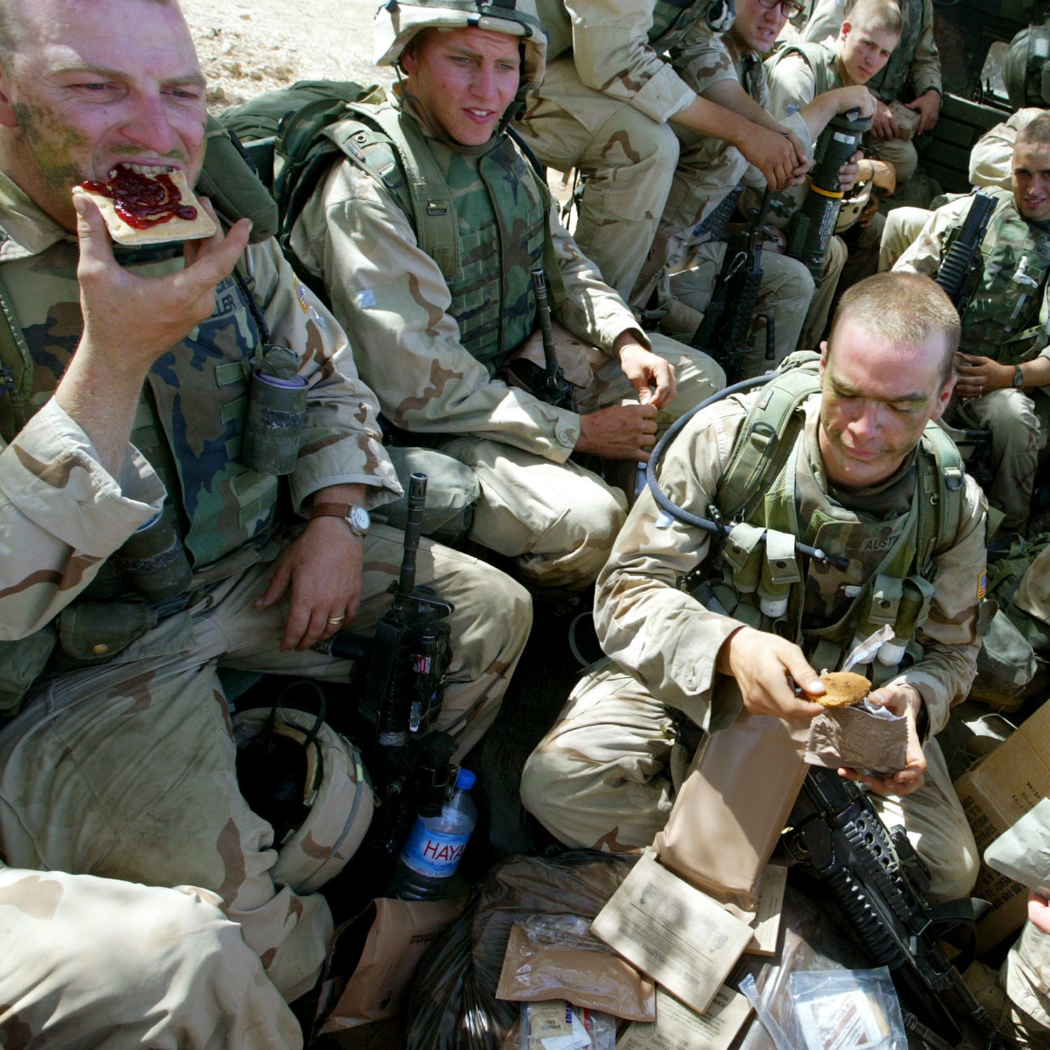 U.S. soldiers from the 173 Airborne Division eat MRE's and sit packed into a truck, shortly before pulling out after an operation in Hawija, northern Iraq, Tuesday, May 20, 2003. Hawija is known by many Iraqis to have been a major base for Baath Party leaders and a base of operation for Iraqi secret police. (AP Photo/Brennan Linsley)
