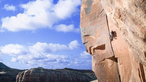 While most of us were waiting in airport security and Thanksgiving traffic, a couple hundred climbers were heading south to Indian Creek, Utah. The Creek, 40 miles south of Moab, is a crack-climbing mecca, chock-full of legendary routes for those willing to suffer.
For the past decade or so, Thanksgiving has brought those masochists out in force, coming together to bloody their knuckles on gritty sandstone and split pumpkin pies pulled out of dumpsters. The gathering, informally dubbed Creeksgiving, is a last hurrah of sorts, a chance to climb a few more pitches in the sun before trading climbing shoes for ski boots—or at least crampons.
Bozeman-based photographer and climber Seth Langbauer was back this year for his third Creeksgiving, drawn to the red rock desert to log one last week of climbing before the snow started to fly. “There’s no service, so there’s this whole little beatnik climbing community communicating through notes left at message boards,” he said. “Everyone’s down there for the same reason: to hang out in the sun and climb cracks.”
Photo: Crack climbing is just what it sounds like: Climbers use special techniques to follow fissures up a wall. Indian Creek is home to a range of crack sizes, from those just big enough for a fingertip to chimneys wide enough to crawl inside and shimmy up. Looking for a break from hand cracks, climber Jake Woodland, who’s been living in his car while traveling from crag to crag, jumped into the wide crack of Big Baby. To inch up the 5.11 route, Woodland had to wedge entire limbs into the crack, topping out with bloody knees and elbows. Said Langbauer, “Shorts were a bad choice.”