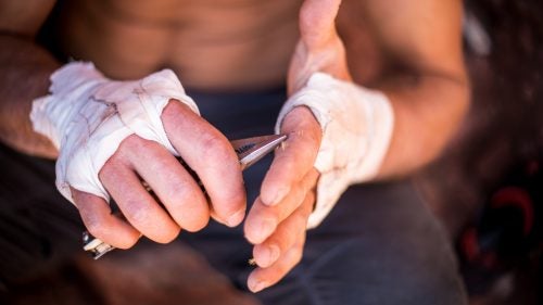 Hamilton Holland came to the Creek from Flagstaff for perfect cracks and the chance to meet up with friends from Montana. While scouting a route, he tripped on a cactus. Here he sits in the shade picking spikes from his hand.
