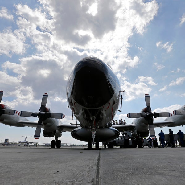 Visitors line up to tour the National Oceanic and Atmospheric Administration's WP-3D Orion turboprop 'Hurricane Hunter' at New Orleans Lakefront Airport in New Orleans, Wednesday, May 21, 2014. The aircraft is used by scientists on research missions to study various elements of a hurricane, flying through the eye of the storm several times each flight. The plane is also visiting Corpus Christi, Texas, Houston, Tallahassee, Fla.; and Tampa, Fla. (AP Photo/Gerald Herbert)