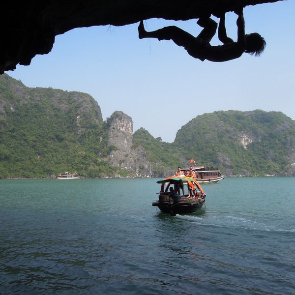 Nguyen climbs slick limestone over the waters of Cat Ba Island in Ha Long Bay.