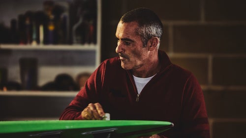 McNamara waxes his board in the warehouse. Silva says he can sometimes sense nervousness among the surfers just beneath the surface of their cool demeanors. “I like to think the camera is quite revealing,” he says.