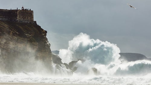In October, as a winter swell began to form in the east Atlantic, the best big-wave surfers in the world descended upon the small, quiet fishing town of Nazaré, in Portugal. It’s here where, each year, hard- chargers like Andrew Cotton, Hugo Vau, and Garrett McNamara—who, in 2013, surfed a record-setting 100-foot wave in Nazaré—come to ride the biggest and some of the most dangerous waves in the world.
This year, Portugal-born, London-based photographer André Silva went to Nazaré to shoot these brave watermen doing what they do best. But unlike the hundreds of other photographers who shoot the athletes from the vantage of the town’s famous lighthouse, Silva, who is old friends with many of these surfers, followed them for weeks. The result: a tense, intimate look at world-class athletes—before, during, and after their death-defying rides.
These photos were originally published on Wonders.
Photo: Most of the waves in Nazaré move in from the northwest, towards this rocky point. One of the biggest concerns among surfers is falling too close to the lighthouse, as doing so would likely force them into the currents smashing up against the rocks. “All the surfers are mindful of it,” contends Silva, “but the biggest waves actually break pretty close to the lighthouse.”