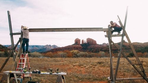 Collins and a local contractor built a structure that stands 20-feet wide by 12-feet tall, on which they hung windows collected from the Habitat for Humanity Restore and through Craigslist. “I’m looking through the windows into the Sedona desert, so these beautiful towers are not only beyond the art, but are part of the art.”
