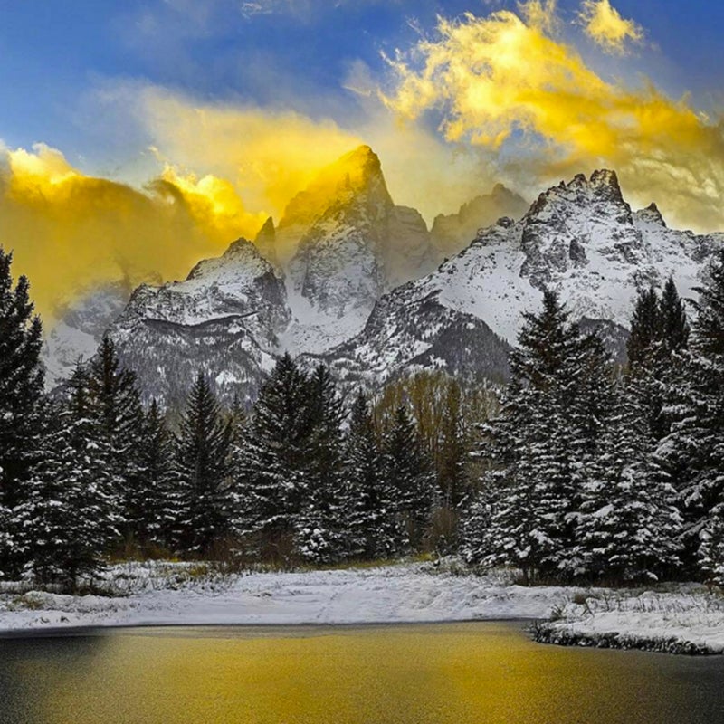 Golden clouds are reflected in the ice of this frozen pond at Schwabacher Landing, home to beavers, ospreys, and spotted frogs.