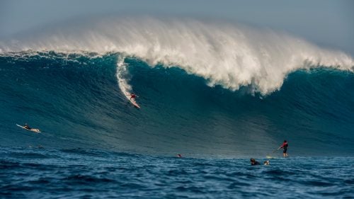 Two weeks ago, surf photographer Ryan Moss was at his home in San Jose, California, when he got a text about a swell headed towards Maui’s North Shore—an area that, due to the size and potential lethality of its waves, most surfers simply refer to as Jaws. At first, he was skeptical. The swell was three days out, and they can easily change in that time. Plus, many of Jaws’ swells peak in the middle of the night, when even the best big-wave riders won’t surf it. Moss wasn’t sure he’d bother.
Then about 48 hours before the swell was expected to arrive, Moss got an email from his forecaster: “We’re going to see some of the biggest waves we’ve ever seen. It’s going to be a historic day.” He scrambled to get everything lined up—flights, transportation, equipment, jet skis, and ski pilots—and two days later, on the back of a jet ski under bright afternoon Hawaiian sun, he was in the water with dozens of surfers and photographers capturing what many are calling the biggest day of paddle-in surfing in Jaws’ history.
Here, alongside photos from award-winning, Los Angeles-based surf photographer Fred Pompermayer, you’ll find some of Moss’ best images.
Photo: It’s tough to give an exact height of the waves but Moss guesses the biggest ones were 60-to-70 feet tall. Aaron Gold (center) caught what most likely was the largest wave of that day, seen here. Moss was attending to renowned surfer Ian Walsh’s brother, D.K., who suffered whiplash after a bad spill, when Gold dropped in. “I saw him out of the corner of my eye and shot really quick,” says Moss. Unfortunately, Gold almost got hurt as well on this wave. “He got destroyed,” says Moss. “He made it to the bottom of the wave, had nowhere to go, and the wave landed on top of his head.”
