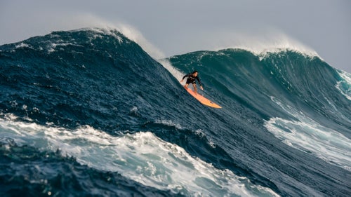 Eli Olson, a promising 23-year-old Hawaiian, has become a regular at Jaws in recent years. Here, he catches a modest wave that, during any other swell, would have most likely been the biggest of the day, says Moss. The streak of light blue water in the foreground is the trail of a passing photographer jockeying for position—evidence of the day’s chaos.