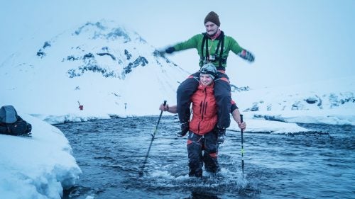 December 28: Rijnbeek (in red) wore waterproof-breathable boots rated to -90˚C to ferry members and their equipment across the river Bláfjallakvísl. Rijnbeek made the trip at least 10 times, and saved Smith (in green) for last. Smith said he was courting disaster by riding on Rijnbeek’s shoulders rather than on his back, but he said it was important to inject some levity into the trip.