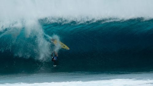 From heat two on the first day of competition, Nic von Rupp of Portugal goes head-first toward Pipe’s bottom. According to photographer Jack Morrissey, offshore winds that day held the lips of the breaking waves back enough to interfere with timing.