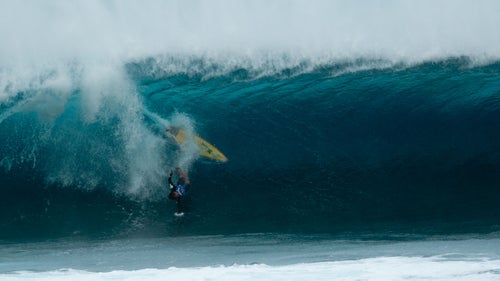 From heat two on the first day of competition, Nic von Rupp of Portugal goes head-first toward Pipe’s bottom. According to photographer Jack Morrissey, offshore winds that day held the lips of the breaking waves back enough to interfere with timing.