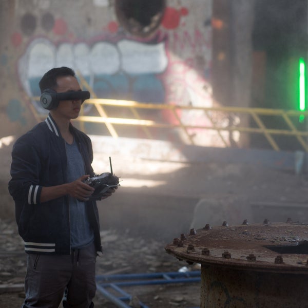 Drones race through neon-lit gates and up staircases doing 80 mph.