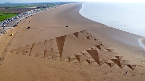 Although he prefers the texture of snow, Beck has done around 50 sand drawings. Sand art, he says, is a “race against the incoming tide.” Here, a large-scale, 3D Sierpinksi triangle adorns Brean Beach in England.