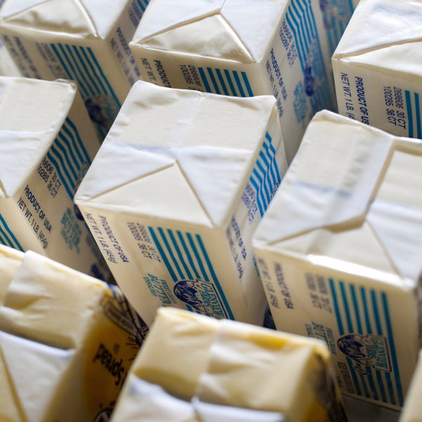 pounds of butter lined up in row on a table. The butter is being warmed up to room temperature for a commercial baker.