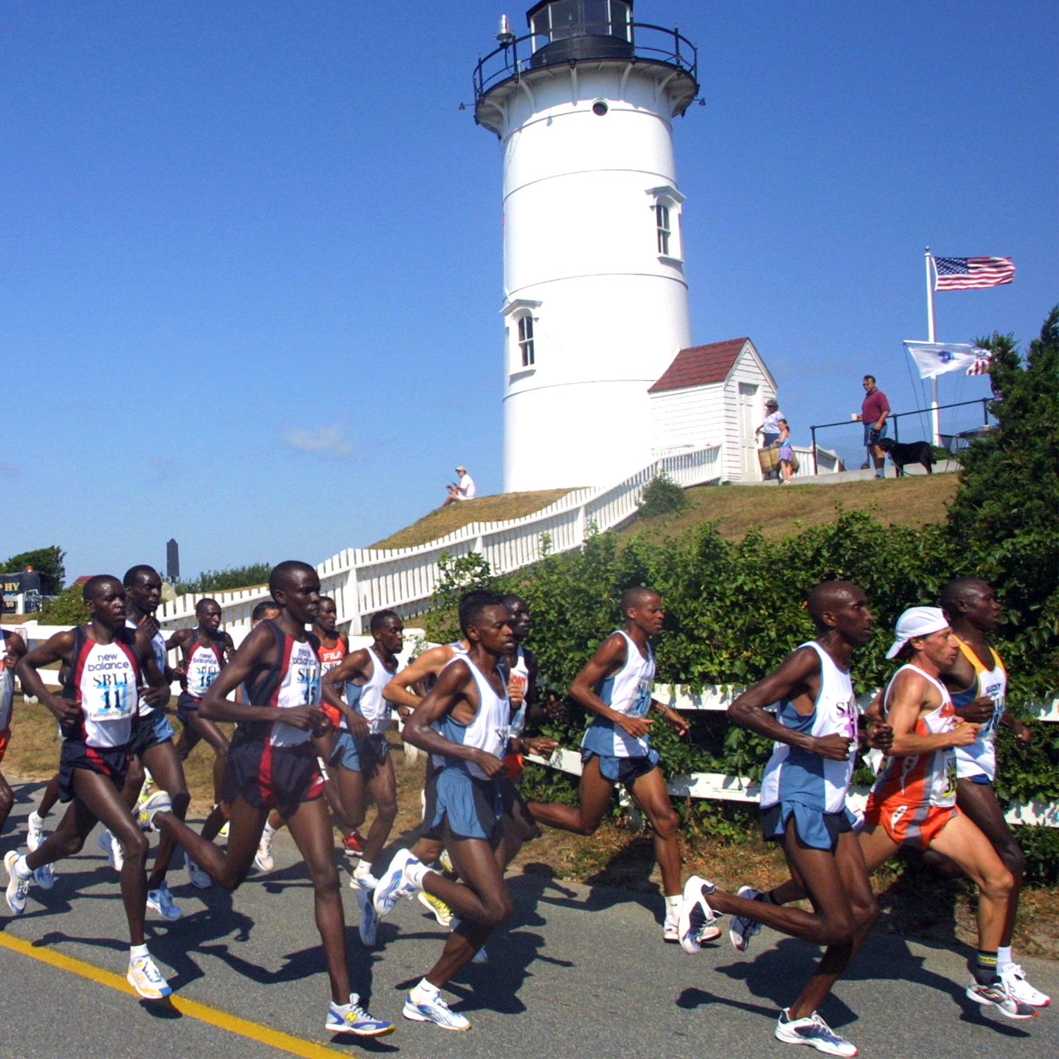 Frontrunners pass Nobska Point Lighthouse during the 30th annual Falmouth Road Race in Falmouth, Ma., Sunday, Aug. 11, 2002. Kenyans John Korir and Lornah Kiplagat were the first man and woman to cross the finish line. (AP Photo/Julia Cumes)