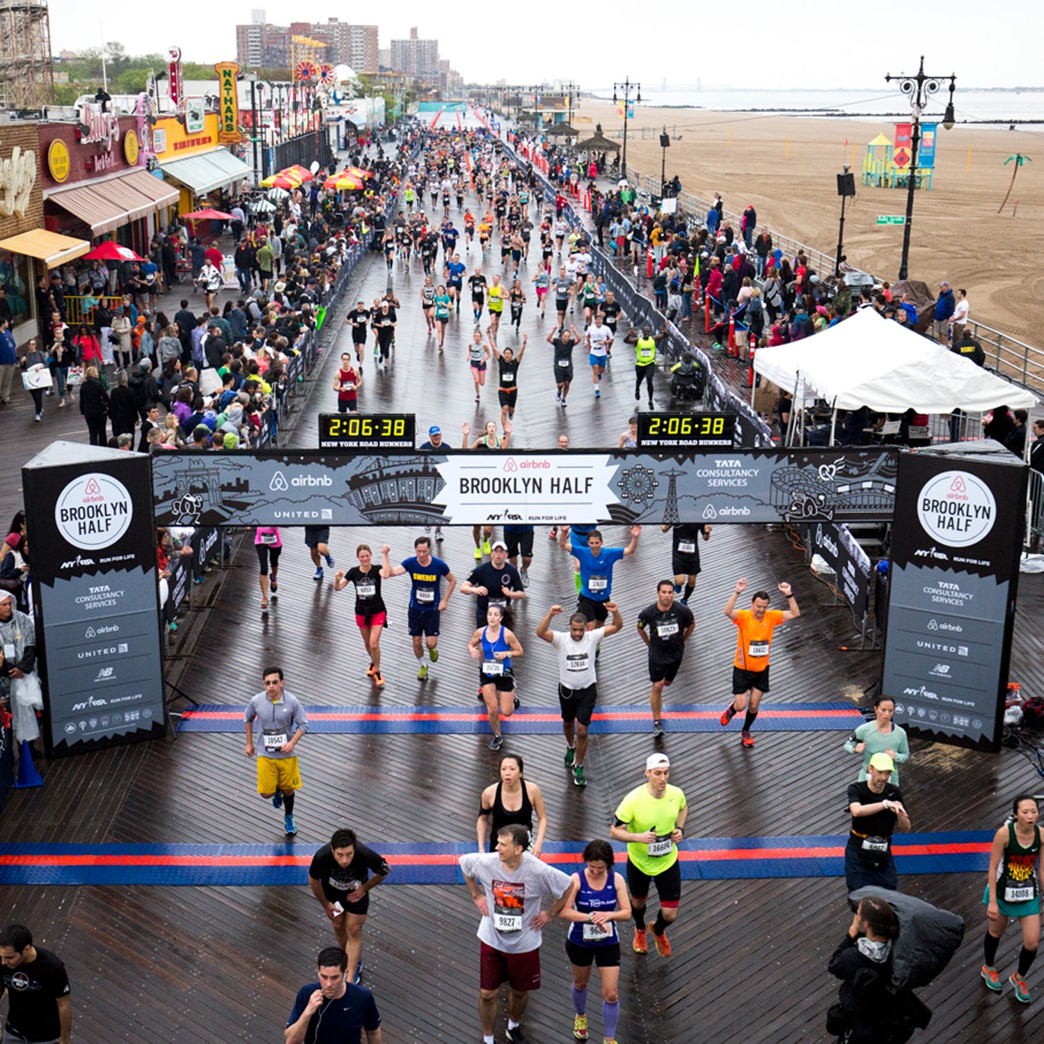 Runners celebrate their finish in the Airbnb Brooklyn Half, Coney Island, on May 16, 2015. (Courtesy NYRR)