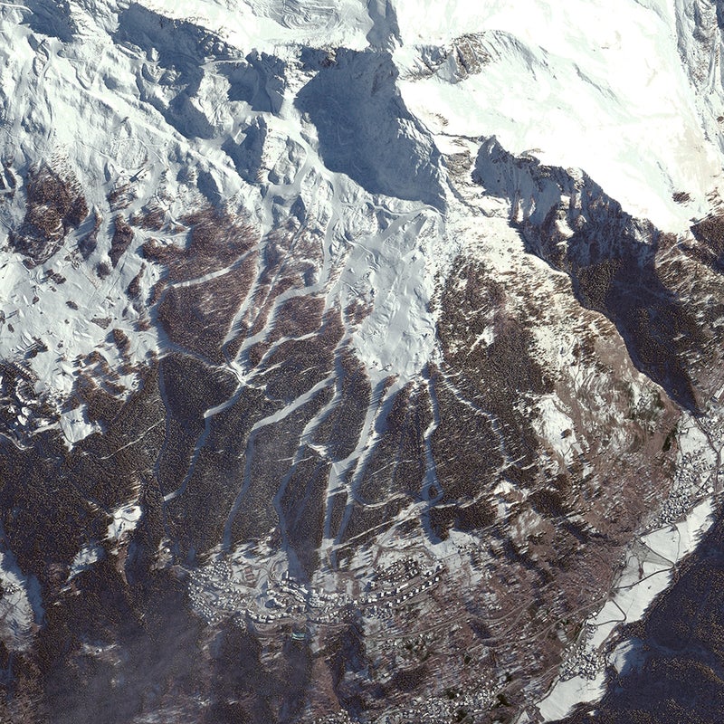Paradski encompasses an enormous swath of France’s Graian Alps, including the resorts of Les Arcs, Peisy-Vallandry, and La Plagne. The area is splayed at the base of the massif of le Vanoise: Mts. Pourri, Grande Motte, Grande Casse, and Bellecôte. This October 2012 image shows the gladed pistes of Peisy-Vallandry merging into the hamlets of the same name. In the upper right is the base of the Aiguille Rouse, beyond which lies Vanoise National Park, France’s first national park.