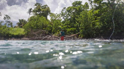 Wade fishing along the coast often means trudging through the jungle, sliding through mud wallows, and sliding along slick volcanic rock. Arriving at the water warrants celebration each time, though at this particular location we’re greeted by skittish little blacktip sharks and unproductive waters.