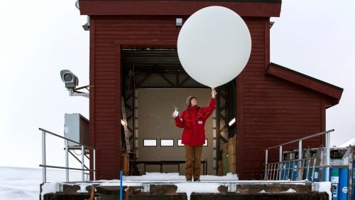 Kathrin Lang preparing a weather balloon for collecting climate data.