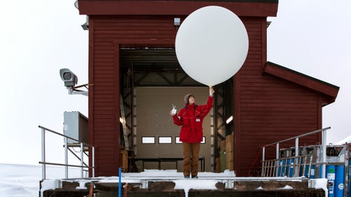 Kathrin Lang preparing a weather balloon for collecting climate data.