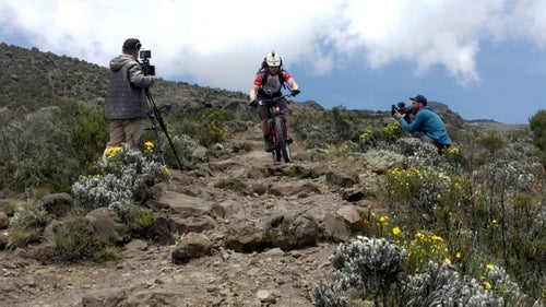 We stayed around Horombu to film and do an acclimatization ride to Zebra Rocks, so named because mineral-rich rainwater flows from the rocks above and streaks the almost-black lava cliff white. It was just an hour and 1,200 feet up, but the trail was technical, so we had to focus on balance, trying not to use too much power, and adjusting to the effects of altitude. We reached the striped majesty feeling strong, filmed a few segments, and then headed back to Camp 1.
On the way back, I reflexively hopped the bike over a small waterbar built into the trail. As I landed, the sharp volcanic rocks took a bite out of my extra tough “Nobby Nick” tire’s sidewall. We’d traveled light for the short ride, meaning I hadn’t packed my other spare. I spent the 30-minute hike back to camp hoping it would be my only mechanical failure of the trip, but hope is never a sound strategy, as I’d find out.