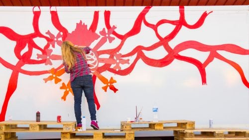 Artist Marina Vargas works on the early stages of her truck design. She focuses heavily on exploring the meaning of religious or magical symbols, and her artwork often involves organic elements like blood and veins.
