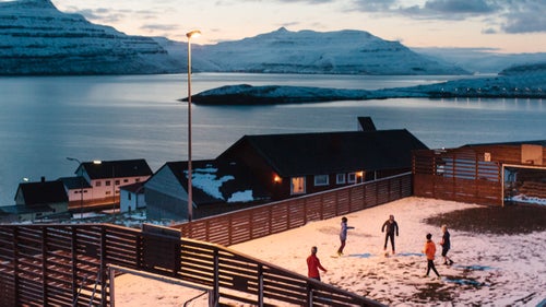 There’s a set of islands in the middle of the chilly North Atlantic, some of which are so sparsely populated that the residents wouldn’t even fill a classroom. The Faroe Islands, an archipelago comprising 18 islands halfway between Scotland and Iceland, make up in an eclectic culture and stunning views what it lacks in population size.
The villages on the smallest and toughest islands have seen a sharp decline in population over time. In a lot of villages, half of the houses stand empty. The Faroese are constantly moving away from the smallest villages, settling in the bigger, main villages. Young Faroese people move abroad—mainly to Denmark, to travel or to pursue a higher education, and mostly they don’t return to their hometown afterwards.
I spent a month on the Faroe Islands last February. My goal was to visit and document life in these incredibly quiet, remote villages. The resulting series is called Føroyar, which is the name of the country in Faroese—a language that is spoken in the world mostly by people living on the islands, or who have moved elsewhere from the islands.
Photo: Children playing soccer in the village of Nes on Eysturoy Island. Population: 29.