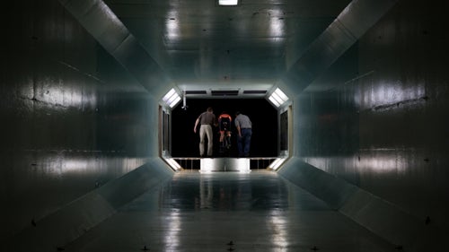 The secret to speed can be found in a nondescript building just north of San Diego off I-5. For the past 69 years, companies have tested the aerodynamics of their planes and missiles in the city’s wind tunnel. Now cyclists use the facility, too, with the goal of finding the ideal equation that maximizes speed while minimizing power output. Earlier this year, U.S. pro bike team Rally Cycling visited the wind tunnel with three of its top time-trialists—Rob Britton, Adam de Vos, and Evan Huffman—to dial in their body positions before the season’s big races, including this week’s Tour of California. The team spent a day in the tunnel under the guidance of HED Cycling aerodynamics guru Dino Edin, who adjusted each riders’ ergonomics and cockpit mechanics. Here’s an inside look at that process.
Photo: Wind tunnel testing is a science of millimeters. It involves incremental adjustments to a rider’s position and the bike components.