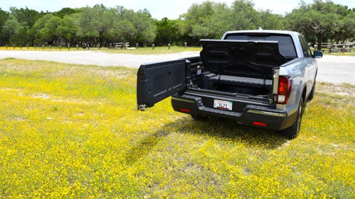 The Ridgeline’s tailgate opens two different ways. Fold it down like a normal gate, or swing it open like a car door.