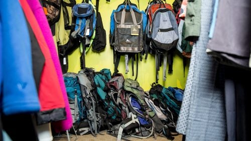 Various used backpacks line the wall at the Repair Lair. The store will also repair mailed-in gear.