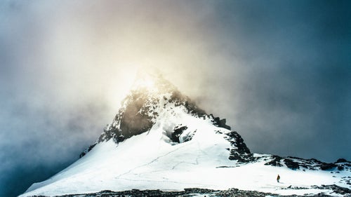 One phone call with native New Zealander Graham Zimmerman led to many more, and, in March 2015, we set off for New Zealand’s South Island with two other friends, Kyle Dempster and Jewell Lund. Our objectives were simple: climb some mountains, eat some meat pies, explore. Months of planning boiled down to a few days of packing and preparation, a string of red-eye flights, and our groggy arrival in Christchurch. From there, we made fast tracks for the Southern Alps, fingers crossed for good weather that never came, with our sights set on the southwest ridge of Mount Aspiring (9,951 feet). Helicopter pilots declined to fly us to the base of our objective, so we opted for the long slog by foot, some 30 miles up the Matukituki Valley. We eventually summited via the southwest ridge. While the climb itself required some heavy trudging, what stood out in hindsight was the array of environments and ecosystems we passed through during our 72-hour descent from Mount Aspiring. We navigated across glaciers and snowfields, jungles and flooded rivers; exchanged greetings with local sheep and shepherds; and eventually arrived in the cascading heart of Fiordland, Milford Sound. Photo: We reached the summit of Mount Aspiring, at 9,951 feet, around 4:30 p.m. on March 8. Heavy gusts swept across the corniced summit. Over the next 72 hours, we traveled through myriad landscapes and microclimates as we descended Aspiring and back into the Matukituki Valley, eventually wending our way into Fiordland.