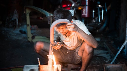 A mechanic in Siliguri working on an exhaust. Eye protection for most welders in India is an afterthought.