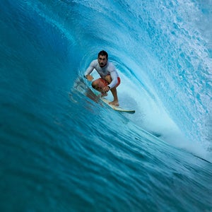 Jameson Kaeo Newtson, a local professor and surfer, riding a wave off the western coast of Tutuila