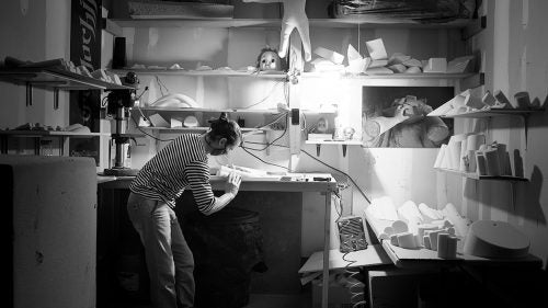 Jason Kehl has shaped holds modeled after everything from baby doll heads to pipes. “I see things all the time that I want to climb,” said Kehl, “like something industrial or like a piece of fruit.” An accomplished outdoor boulderer, Kehl is nevertheless known for his “urban” shapes. Like many shapers, he uses direct light to right lines and spot imperfections in his shapes. When I met Kehl, he was shaping in a single car garage in a suburban Boulder condo complex.