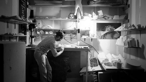 Jason Kehl has shaped holds modeled after everything from baby doll heads to pipes. “I see things all the time that I want to climb,” said Kehl, “like something industrial or like a piece of fruit.” An accomplished outdoor boulderer, Kehl is nevertheless known for his “urban” shapes. Like many shapers, he uses direct light to right lines and spot imperfections in his shapes. When I met Kehl, he was shaping in a single car garage in a suburban Boulder condo complex.