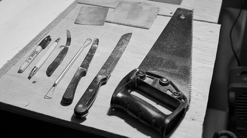Saws, knives, files, wire loops, and sandpaper are the tools of the trade. A shaper often starts by sawing a chunk from a large block of foam. From there he uses progressively more precise tools as the hold takes shape before him. From the finished shape, a manufacturer makes molds. Those molds are then filled with urethane plastic to mass produce the holds originally shaped in foam.