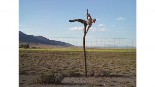 Photographer Lucas Foglia’s widely celebrated book, Frontcountry, took him across much of the American West from 2006 to 2013. He captured nearly 60,000 images over that time and narrowed the final selection down to just 60 shots, all of which explored mining and ranching communities and their interaction with the surrounding landscape. Despite his extensive coverage, Foglia thinks many of the stories he came across are still undercovered. He even included a map in the book as an invitation for other photographers and storytellers to use as a resource. Here, Foglia highlights a few storylines from his book that are far from over. Photo: Tommy trying to shoot coyotes; Big Springs Ranch, Oasis, Nevada, 2012. It was Tommy’s idea to shoot coyotes from the top of a fence pole. I photographed him the moment before he fell off the pole with a loaded gun. When I met Tommy in 2012, it was their last year leasing the Big Springs Ranch. I asked why the ranch, which the Stowells were leasing, was called Big Springs, and he told me there’s so much water on the ranch that water from one spring is piped 30 miles to taps in the city of Wendover. Newmont Mining Corporation, one of the world’s largest gold-mining companies, had recently purchased the 350,000-acre property. Soon after, the company announced the discovery of a multimillion-ounce high-grade gold deposit there, the only significant discovery made in Nevada in the past decade. They renamed the land Long Canyon, and it is currently being developed. Surrounded by desert, Wendover had to find new water.Coyotes are reputed to destroy livestock, poultry, and crops. They especially like watermelon. In most western states, they can be killed throughout the year with no bag limit. Coyote-killing contests are a popular approach. Hunters win prizes for the size or number killed. But coyotes have proven to be adaptive: despite numerous population control efforts, they continue to roam and colonize most of North America.
The complete Frontcountry book can be purchased here.