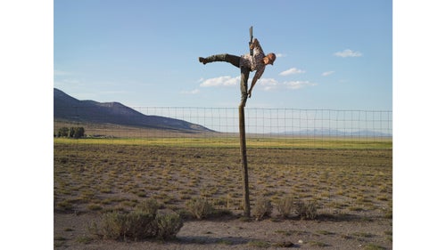 Photographer Lucas Foglia’s widely celebrated book, Frontcountry, took him across much of the American West from 2006 to 2013. He captured nearly 60,000 images over that time and narrowed the final selection down to just 60 shots, all of which explored mining and ranching communities and their interaction with the surrounding landscape. Despite his extensive coverage, Foglia thinks many of the stories he came across are still undercovered. He even included a map in the book as an invitation for other photographers and storytellers to use as a resource. Here, Foglia highlights a few storylines from his book that are far from over. Photo: Tommy trying to shoot coyotes; Big Springs Ranch, Oasis, Nevada, 2012. It was Tommy’s idea to shoot coyotes from the top of a fence pole. I photographed him the moment before he fell off the pole with a loaded gun. When I met Tommy in 2012, it was their last year leasing the Big Springs Ranch. I asked why the ranch, which the Stowells were leasing, was called Big Springs, and he told me there’s so much water on the ranch that water from one spring is piped 30 miles to taps in the city of Wendover. Newmont Mining Corporation, one of the world’s largest gold-mining companies, had recently purchased the 350,000-acre property. Soon after, the company announced the discovery of a multimillion-ounce high-grade gold deposit there, the only significant discovery made in Nevada in the past decade. They renamed the land Long Canyon, and it is currently being developed. Surrounded by desert, Wendover had to find new water.Coyotes are reputed to destroy livestock, poultry, and crops. They especially like watermelon. In most western states, they can be killed throughout the year with no bag limit. Coyote-killing contests are a popular approach. Hunters win prizes for the size or number killed. But coyotes have proven to be adaptive: despite numerous population control efforts, they continue to roam and colonize most of North America.
The complete Frontcountry book can be purchased here.