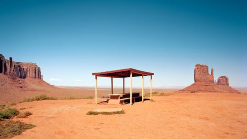 Monument Valley, Arizona. This is one of the last picnic tables in Monument Valley. There were many more, but the rest were demolished so that a hotel overlooking the valley could be built. This table is located in a pull-off, offering a great view of The Mittens rock formations in the background.