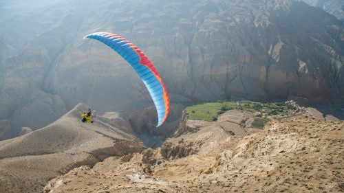 Last month, five friends set out from Pokhara, Nepal with mini-paragliders and 1950’s Royal Enfield motorcycles on a ten-day mission to the once forbidden Kingdom of Mustang in Tibet. The group of seasoned athletes and travelers made up of Nick Greece, Jamie and Isabella Messenger, and Cody and Cherise Tuttle, didn’t finalize their plans until a week out, which was kind of of the point. They wanted an adventure and a good ol’ figure-it-out style trip. Half the group was relatively new to paragliding—the other half was new to motorcycling. The table was set for some memorable experiences. Here, photographer