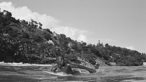 Samuel Jules, Surf Haiti's top competitor, paddles out in the early stages of the competition.