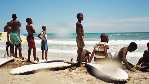 Haiti would be a rare sight on anyone's list of surfing hotspots. Despite beautiful beaches and solid breaks, the country is better known as a poster child for the failure of international aid in the wake of two devastating natural disasters—not to mention issues of violence, disease, and endemic corruption that persist today. However, since 2010 a small group of aid workers has been teaching local kids to surf the waves of Kabic Beach, roughly 45 minutes outside of Haiti's cultural capital, Jacmel. Many of these kids, despite growing up on the water, first had to learn to swim. This April, Surf Haiti hosted the country’s first surf competition matching up against a team from the bordering Dominican Republic. Photographer Mike Magers was there to capture the event, and what turned out to be a non-stop beach celebration. Photo: Contestants and spectators anxious to get back in the water while watching the heats from the beach.