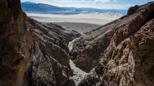 Eureka Dunes from Hammer Mjolnir Canyon. May 24, 2016.
Extreme conditions leave much of the park unpopular, unvisited, and undisturbed but full of splendid beauty. And while there are fewer “firsts” available to true adventurers, Death Valley has in the past decade provided a select group of canyoneers the opportunity to rack up hundreds of spectacular first descents through the park’s dramatic canyons. Of these first descenders, Scott Swaney, 68, has distinguished himself as particularly committed to exploring, logging, and naming all of Death Valley’s numerous canyons.