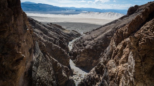 Eureka Dunes from Hammer Mjolnir Canyon. May 24, 2016.
Extreme conditions leave much of the park unpopular, unvisited, and undisturbed but full of splendid beauty. And while there are fewer “firsts” available to true adventurers, Death Valley has in the past decade provided a select group of canyoneers the opportunity to rack up hundreds of spectacular first descents through the park’s dramatic canyons. Of these first descenders, Scott Swaney, 68, has distinguished himself as particularly committed to exploring, logging, and naming all of Death Valley’s numerous canyons.
