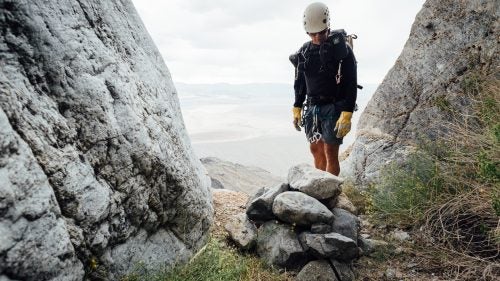Swaney inspects a rock-pile anchor in Sand Witch Canyon. May 21, 2016.
We are now climbing a steep ridgeline toward an unnamed summit, at which point we’ll traverse around and drop into a drainage that will deepen into a canyon. I ask Plummer if I can trust Swaney. Plummer’s accompanied him on about 30 canyoneering trips in Death Valley, including many first descents. He tells me that Swaney knows what he’s doing. He also tells me that I need to make my own decisions about what is safe and what is not. I respect his response.