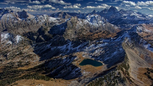 Grand Teton National Park, while not particularly enormous in surface area, has a tremendous density and variety of terrain, from glaciers to massive lakes, and of course Grand Teton herself (13,770’, right horizon). On this particular flight after some early season snowfall, I decided to head into the difficult-to-reach northwest corner of the park to photograph scenes that few visitors will ever see. What I had to get over was the worry of an in-flight emergency in this wilderness, though the resulting photography was every bit worth it.
