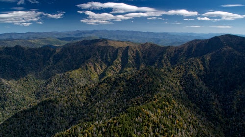 While in hot pursuit of the peaks over 6,000 feet in the Southeast, I found myself spending some time in Great Smoky Mountains National Park. On this particular day, lenticularis clouds developed, which are lens-shaped clouds that are caused by winds arcing through the atmosphere due to interactions with mountains. They are a good indication that the flight is going to be bumpy. I had the challenge of flying in extremely remote and forested terrain with no emergency options in the Smokies, coupled with what I call “Mr. Toad’s Wild Ride” in the sky.
From the book “Appalachian Altitude: Flying the Highest Peaks of the South.”
