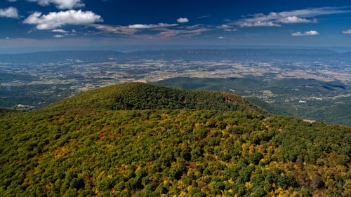 The Blue Ridge Parkway continues on as Skyline Drive through Shenandoah National Park, both roads of which are works of art as viewed from the air. I have traversed the Shenandoah Valley many times in the plane, and each time it was incredibly peaceful and beautiful. This angle looks west from the park into the Shenandoah Valley.
From the book “Flying the Blue Ridge Parkway.”
