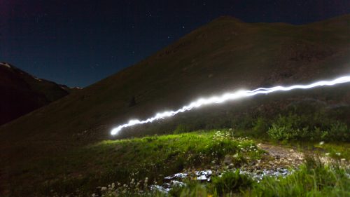 A competitor’s headlamp illuminates the trail to American Basin. Since the final cutoff time for the Hardrock 100 is 48 hours, competitors must be prepared to run non-stop through the night.