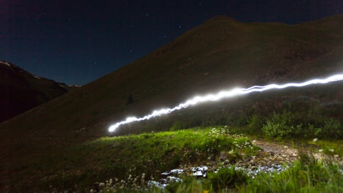 A competitor’s headlamp illuminates the trail to American Basin. Since the final cutoff time for the Hardrock 100 is 48 hours, competitors must be prepared to run non-stop through the night.