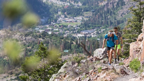 Joe Grant and his pacer make their way up Bear Creek with Ouray, Colorado, in the background. To navigate Hardrock’s physical and mental tolls, many runners choose to run with partners or pacers, so they’re less likely to get lost or make poor judgments.